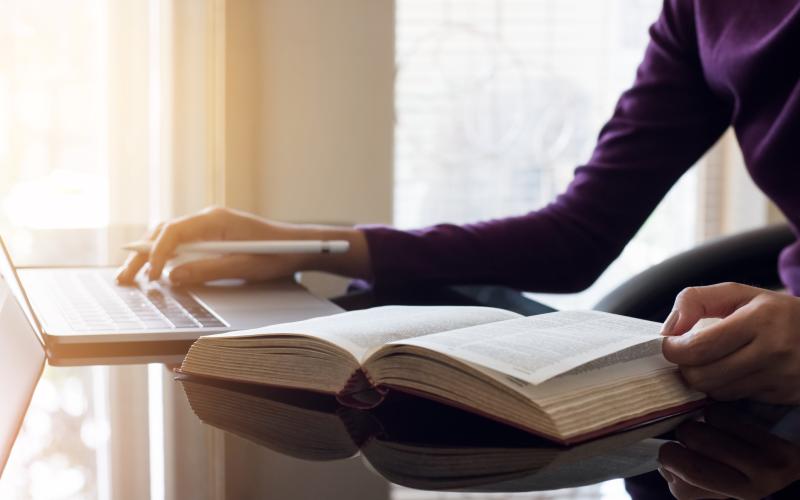 Dictionary and laptop is being used for translation Dictionary and laptop is being used for translation